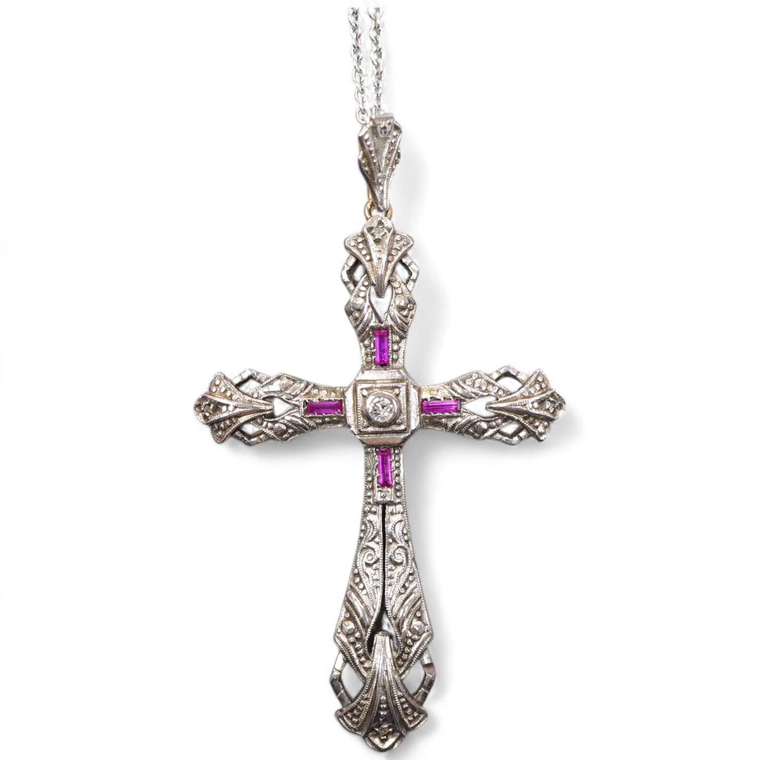 A synthetic ruby and diamond pendant, designed as a foliate cross, set with a brilliant-cut diamonds and step-cut synthetic rubies, on a chain necklace, mounted in gold, pendant length 5.4cm, stamped 18K, necklace length